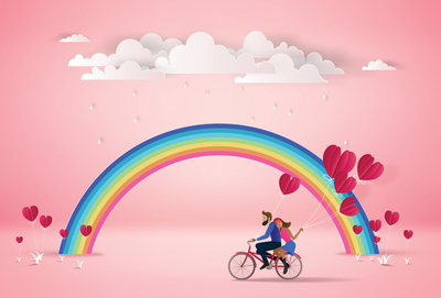 Ehepaar auf einem Fahrrad mit dem Regenbogen
